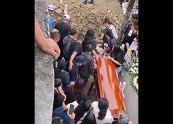 Enlace a Un repartidor llega con flores a un funeral y se cae al hoyo